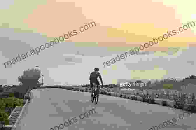 A Cyclist Climbing A Steep Mountain Pass With A Breathtaking View In The Background. The Lions On The Road: Cycling London To Cape Town For Save The Children Fund