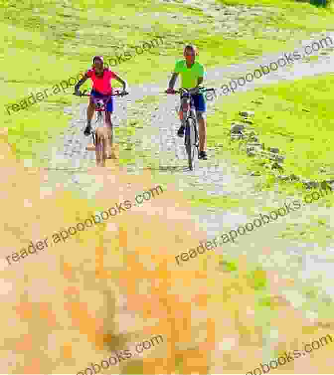 A Cyclist Riding Through A Rural Village, Surrounded By Smiling Children Waving And Cheering. The Lions On The Road: Cycling London To Cape Town For Save The Children Fund