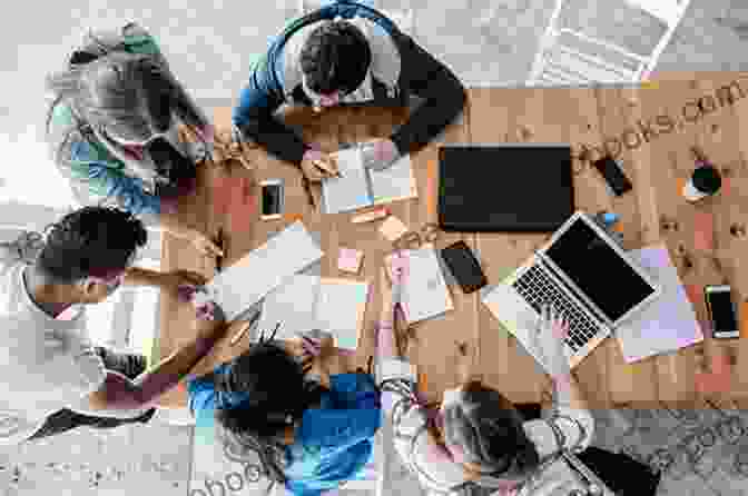 A Group Of People Huddled Around A Table, Discussing And Brainstorming Ideas Yes And: How Improvisation Reverses No But Thinking And Improves Creativity And Collaboration Lessons From The Second City