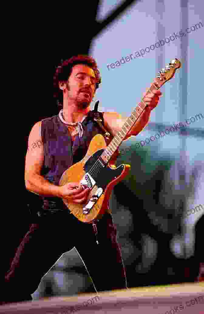 Bruce Springsteen Performing Live On Stage, With His Guitar Raised High, Surrounded By A Sea Of Fans. Life And Lyrics : Badlands Justin McRoberts